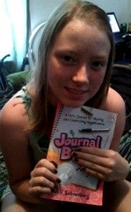 Happy Girl with Copy of Journal Buddies